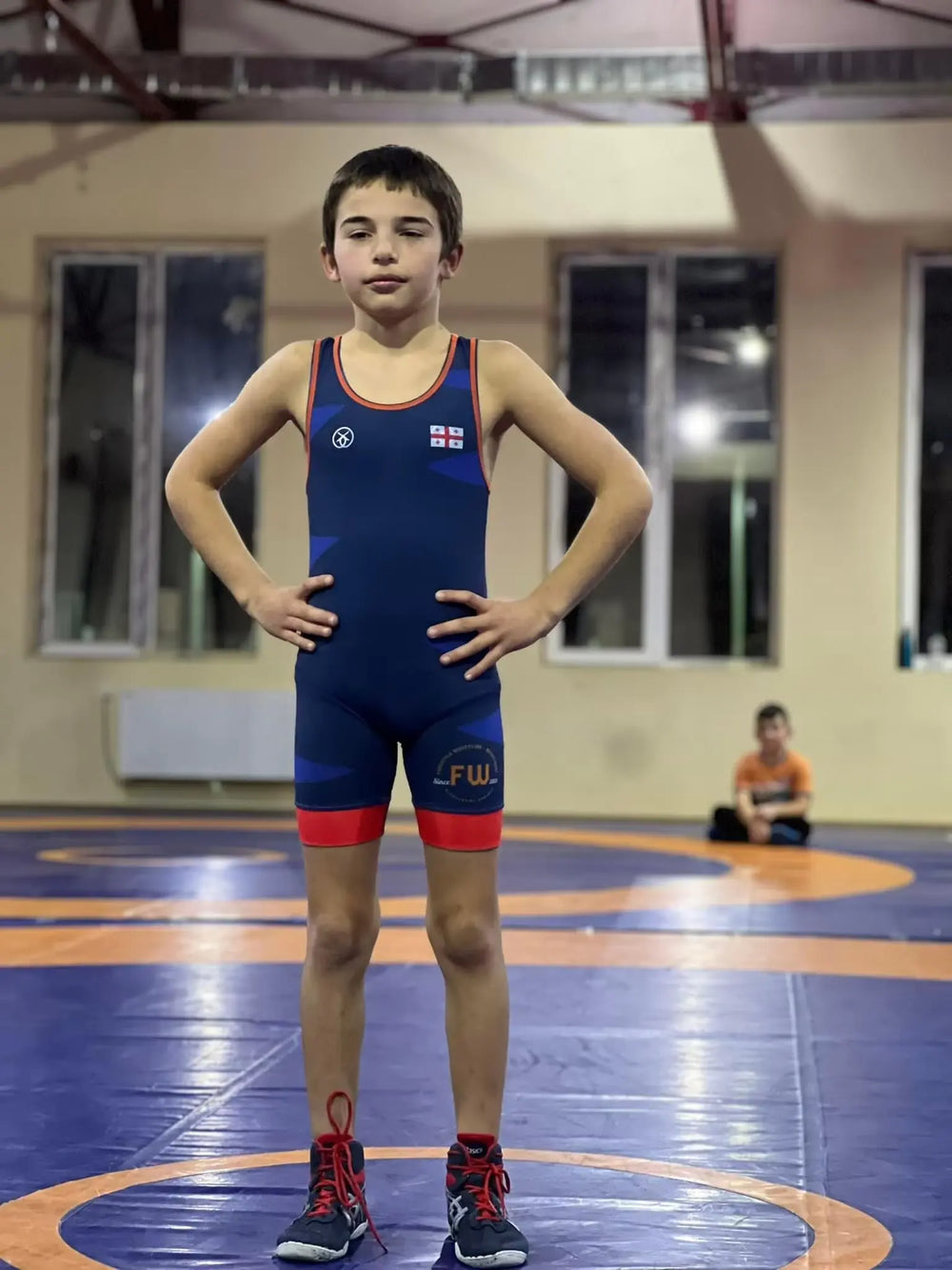 Youth tournament mat-ready wrestling singlet on athlete