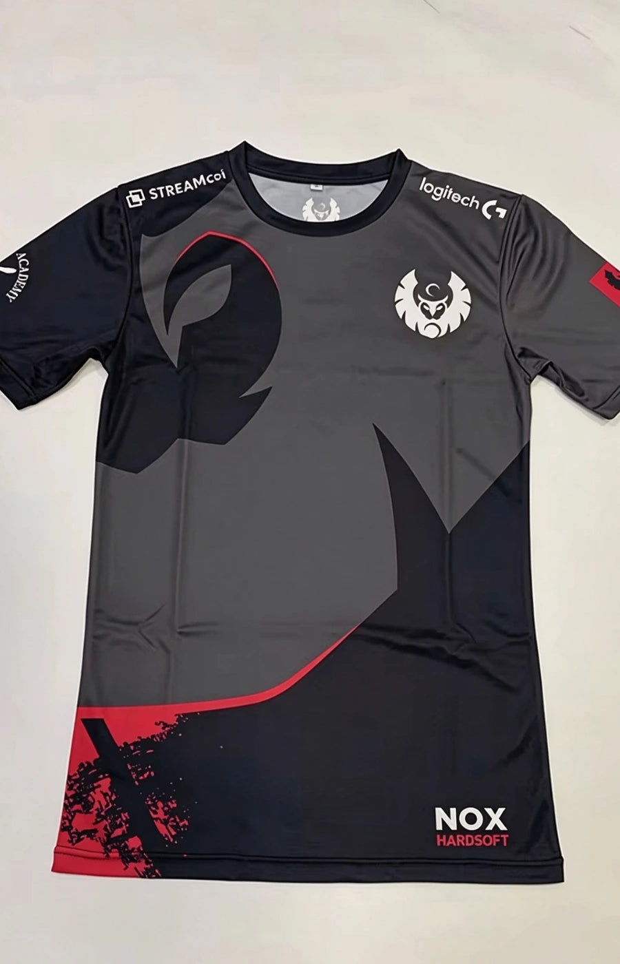 Charcoal dark esports jersey with neon pink gradient and teal emblem