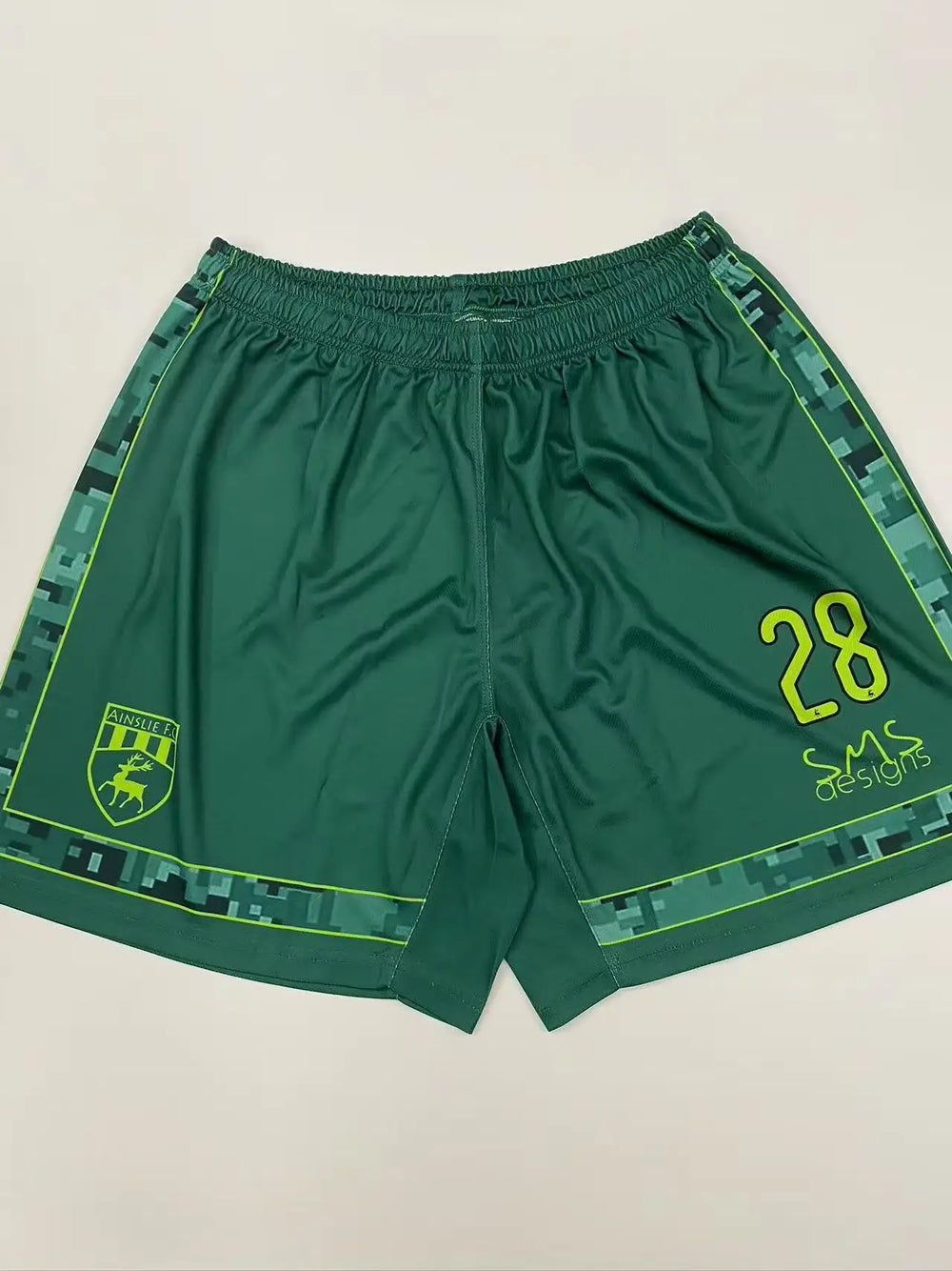 Forest green custom soccer team shorts with yellow accents